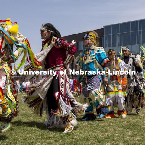 Powwow participants join the opening intertribal circle during the UNITE event. 2022 UNITE powwow to honor graduates (K through college). Held April 23 on the greenspace along 17th Street, immediately west of the Willa Cather Dining Center. This was UNITE’s first powwow in three years. The MC was Craig Cleveland Jr. Arena director was Mike Wolfe Sr. Host Northern Drum was Standing Horse. Host Southern Drum was Omaha White Tail. Head Woman Dancer was Kaira Wolfe. Head Man Dancer was Scott Aldrich. Special contest was a Potato Dance. April 23, 2023. Photo by Troy Fedderson / University Communication.